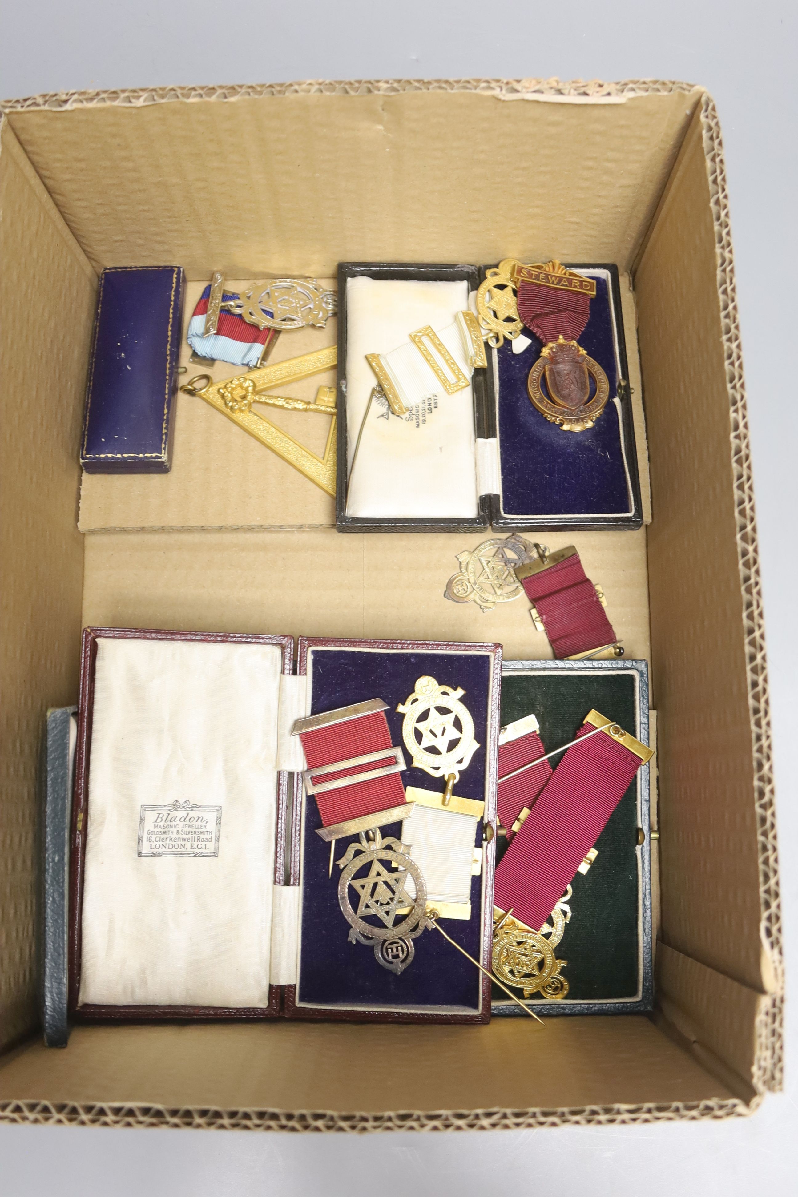 A group of Masonic sashes with metal medals and a collection of gilt metal cased medals